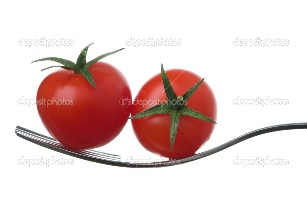 Two cherry tomatoes on a fork