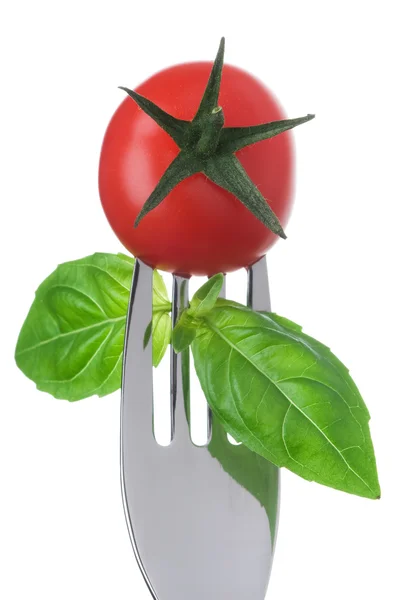 Tomato and basil on a fork on white — Stock Photo, Image