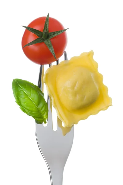 Ravioli pasta tomato and basil on fork against white background — Stock Photo, Image