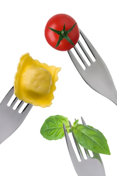 Ravioli pasta basil leaves and tomato on forks — Stock Photo, Image