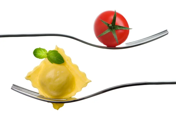 Ravioli pasta parcel and basil garnish on fork white background — Stock Photo, Image