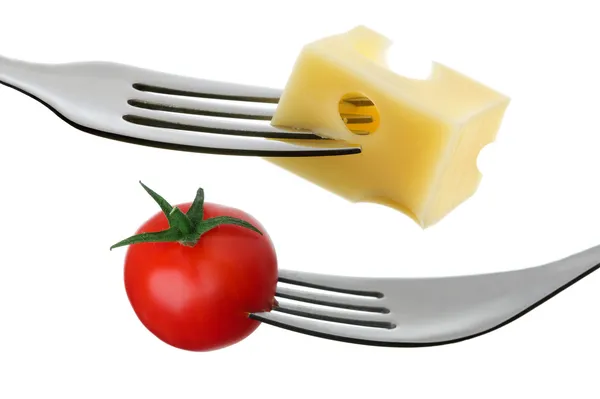 Tomato and cheese on a fork against white background — Stock Photo, Image