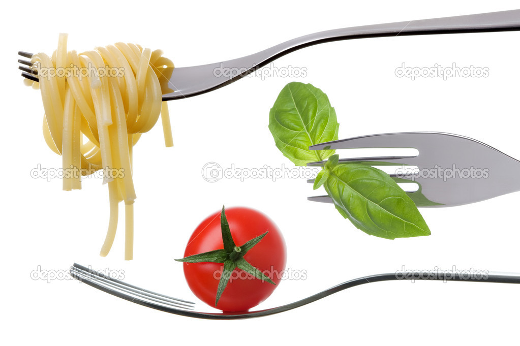 Spaghetti basil and tomato on forks isolated