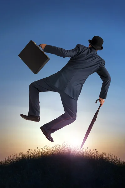 Business success concept businessman kicking heels in air — Stock Photo, Image