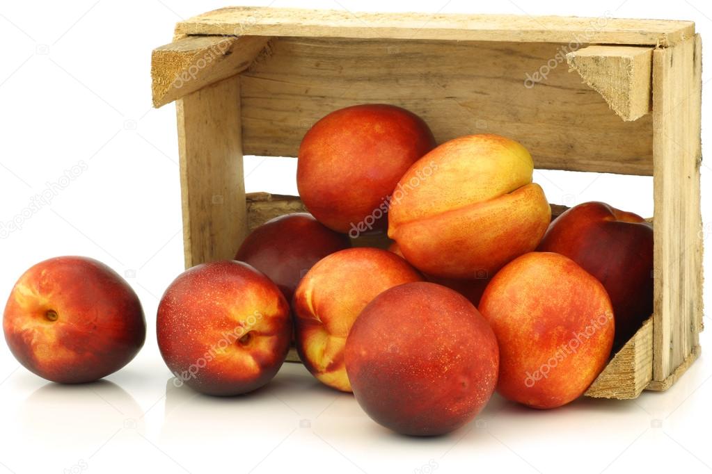 Fresh nectarines in a wooden crate
