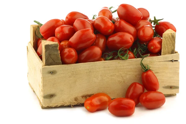 Fresh italian cherry tomatoes on the vine in a wooden crate — Stock Photo, Image