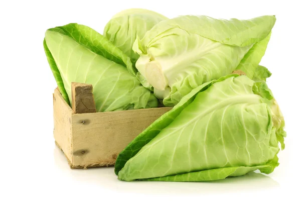 Fresh green pointed cabbages in a wooden crate — Stock Photo, Image