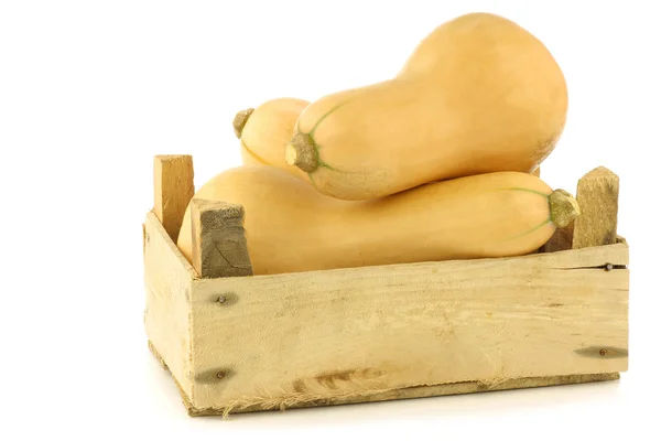 Bottle shaped butternut pumpkins in a wooden crate — Stock Photo, Image