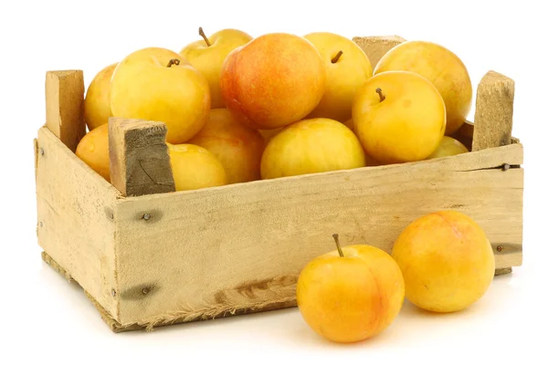 Fresh yellow plums in a wooden crate — Stock Photo, Image