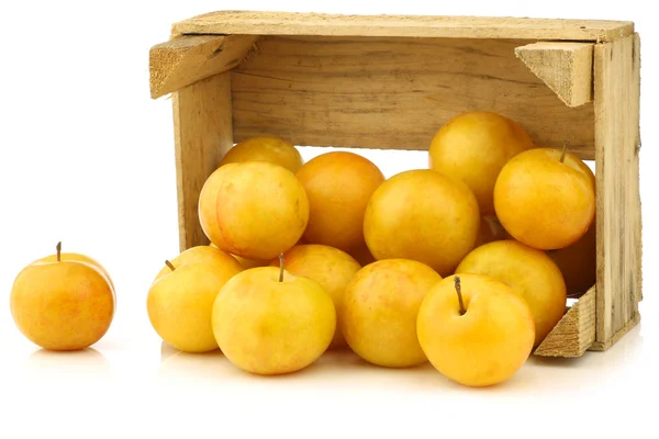 Fresh yellow plums in a wooden crate — Stock Photo, Image