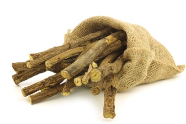 licorice root (sticks) in a burlap bag clipart