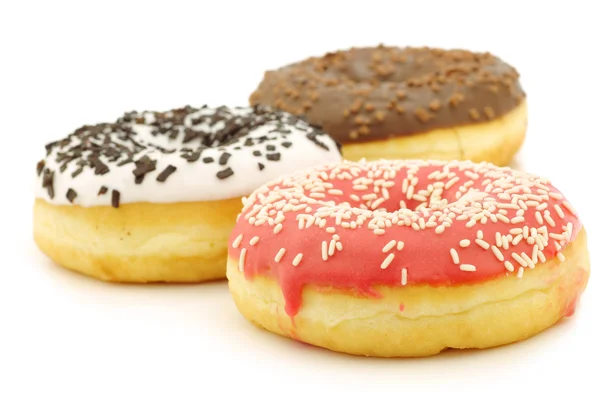 Assorted colorful glazed donuts with sprinkles — Stock Photo, Image