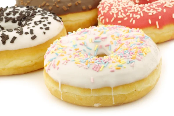 Assorted colorful glazed donuts with sprinkles — Stock Photo, Image
