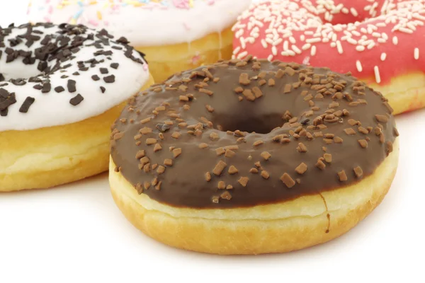 Assorted colorful glazed donuts with sprinkles — Stock Photo, Image