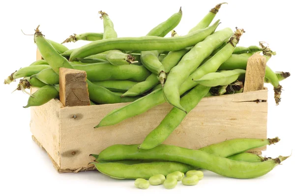 Bunch of broad beans in a wooden box — Stock Photo, Image