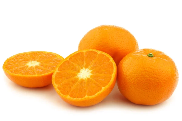 Fresh tangerines and a cut one — Stock Photo, Image