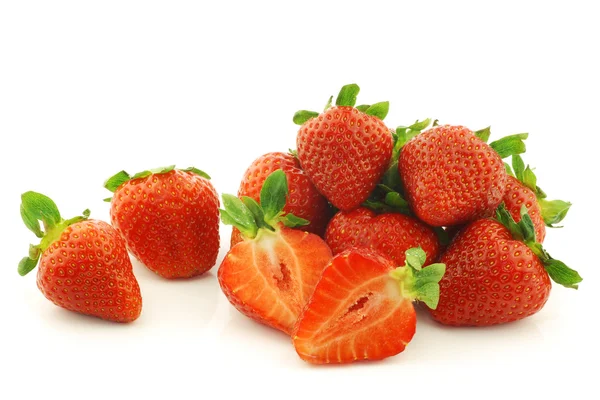 Fresh strawberries and a cut one — Stock Photo, Image