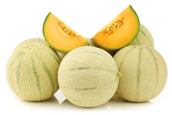 Fresh cantaloupe melons and a cut one Stock Photo