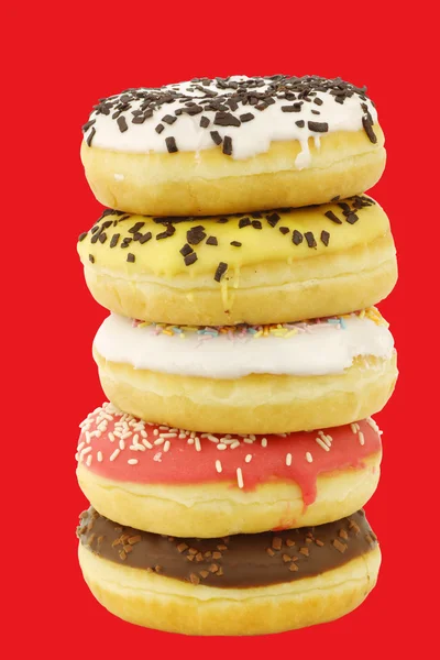 Stacked assorted colorful glazed donuts with sprinkles — Stock Photo, Image