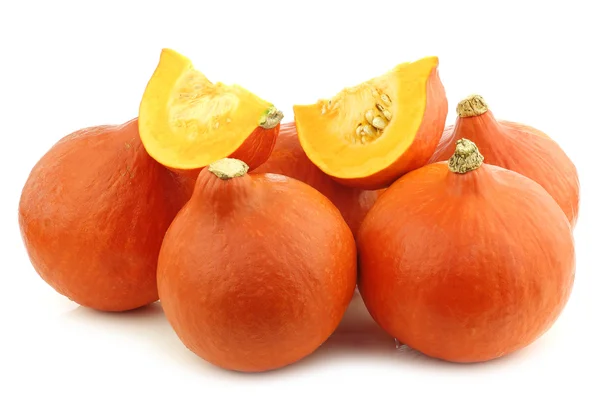 Orange pumpkins and some cut pieces — Stock Photo, Image