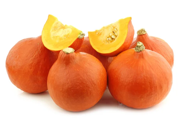 Oranje pompoenen en sommige stukken gesneden — Stockfoto