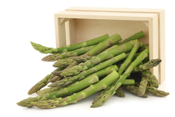 Fresh green asparagus tips in a wooden box — Stock Photo, Image