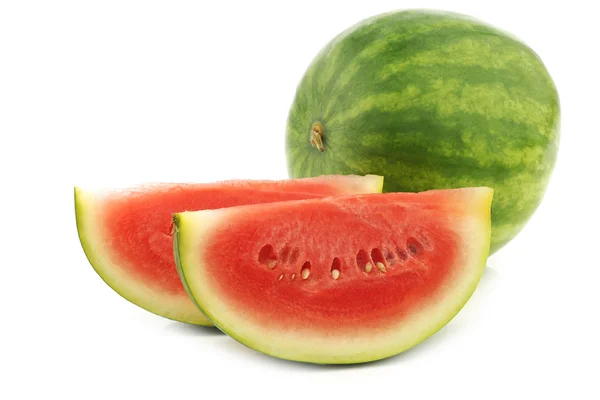 Fresh watermelon and some cut pieces — Stock Photo, Image