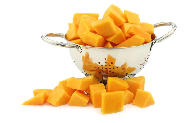 Cut butternut pumpkin blocks in a metal colander — Stock Photo, Image