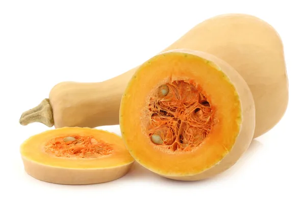 Bottle shaped butternut pumpkin and a cut one — Stock Photo, Image