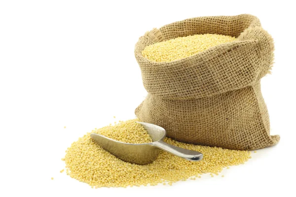 Millet in a burlap bag — Stock Photo, Image