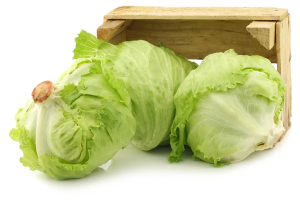 Fresh iceberg lettuce in a wooden crate — Stock Photo, Image