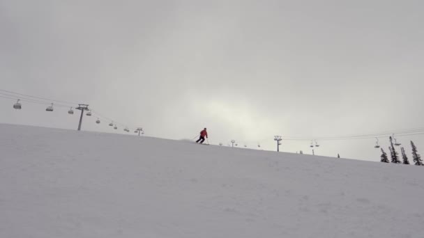 Profesjonalny narciarz Szybki narty na stoku narciarskim w górach W zimie — Wideo stockowe
