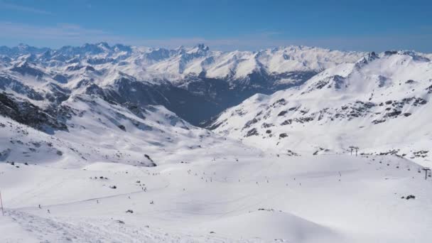 Many Skiers And Snowboarders Skiing Down On Slope In Mountain Ski Resort — Stock Video