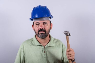 Portrait of 60 years old professional heavy industry engineer/worker wearing hardhat