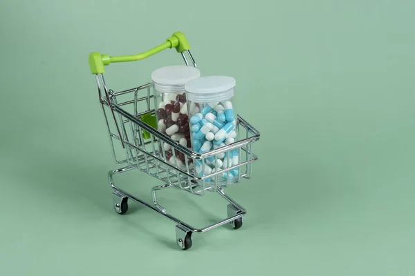 Several Different Packages Pills Small Shopping Car Green Background Medicine — Stock fotografie