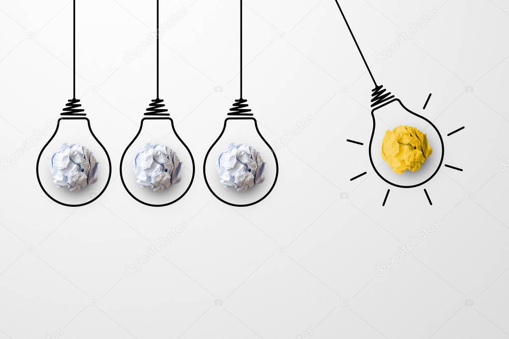 Concept creative idea and innovation. Paper scrap ball yellow colour outstanding different group with light bulb symbol