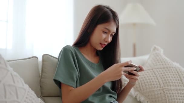 Feliz Joven Asiática Mujer Relajarse Cómodo Sofá Casa Jugando Juegos — Vídeos de Stock