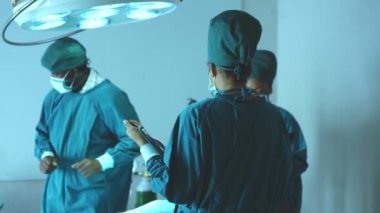 Surgery team operating in a surgical room. Doctor and nurse discuss planning surgery
