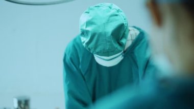 Surgery team operating in a surgical room. Doctor and nurse discuss planning surgery