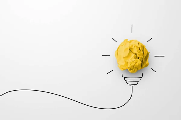 Creative thinking ideas and innovation concept. Paper scrap ball yellow colour with light bulb symbol on white background