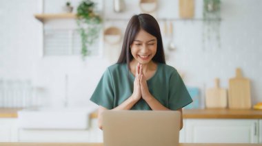 Asyalı bir kadının kazanmasını ya da bilgisayar laptopunda ecommerce alışveriş teklifi almasını kutlayan komik bir coşku. Heyecanlı mutlu kız kazanan başarıyı kutlayan deftere bakıyor.