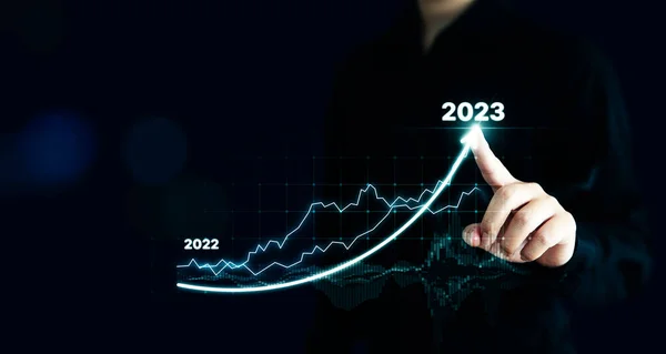 Businessman pointing arrow graph corporate future growth plan. Business development to success and growing growth year 2022 to 2023 concept