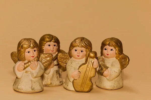 Four of ceramic small angels with music instruments — Stock Photo, Image