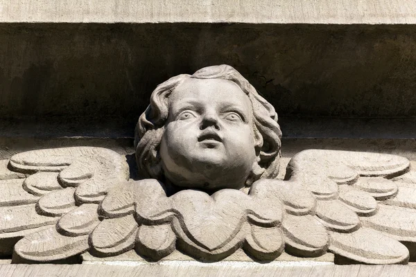 Bas-relief of a small angel on facade of church — Stock Photo, Image