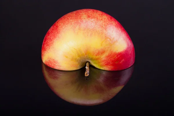 Half of red apple with reflection isolated on black background — Stock Photo, Image
