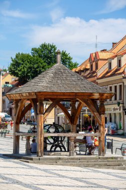 Sandomierz, Poland - July 10, 2020: View on market with  old wooden well. Sandomierz is known for its Old Town, which is a major tourist attraction.