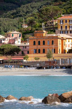 Monterosso al Mare, Cinque Terre - Italy, May 12, 2019: View from the sea on seaside and typical colorful houses in small village, Riviera di Levante