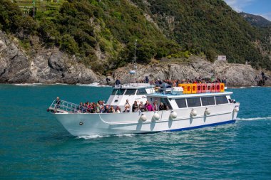 Cinque Terre, Italy, Liguria - May 12, 2019: A cruise ship with tourists on board sails in the Ligurian Sea along the coast between the villages of Cinque Terre