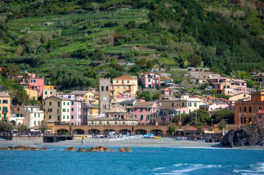 Monterosso al Mare, Cinque Terre - Italy, May 12, 2019: View from the sea on seaside and typical colorful houses in small village, Riviera di Levante