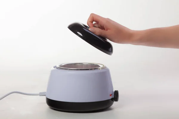 Beyaz arka planda balmumu eriticisi. Salon ekipmanları. Kapağı aç.